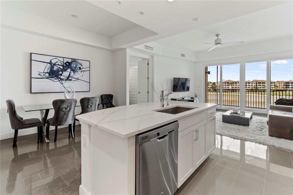 10520 Boardwalk Loop, Unit 302 Bradenton, FL 34202 - Photo 16 of 45 a kitchen with a table chairs stove and cabinets