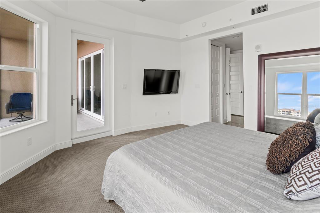10520 Boardwalk Loop, Unit 302 Bradenton, FL 34202 - Photo 23 of 45 a bedroom with a bed and a flat screen tv