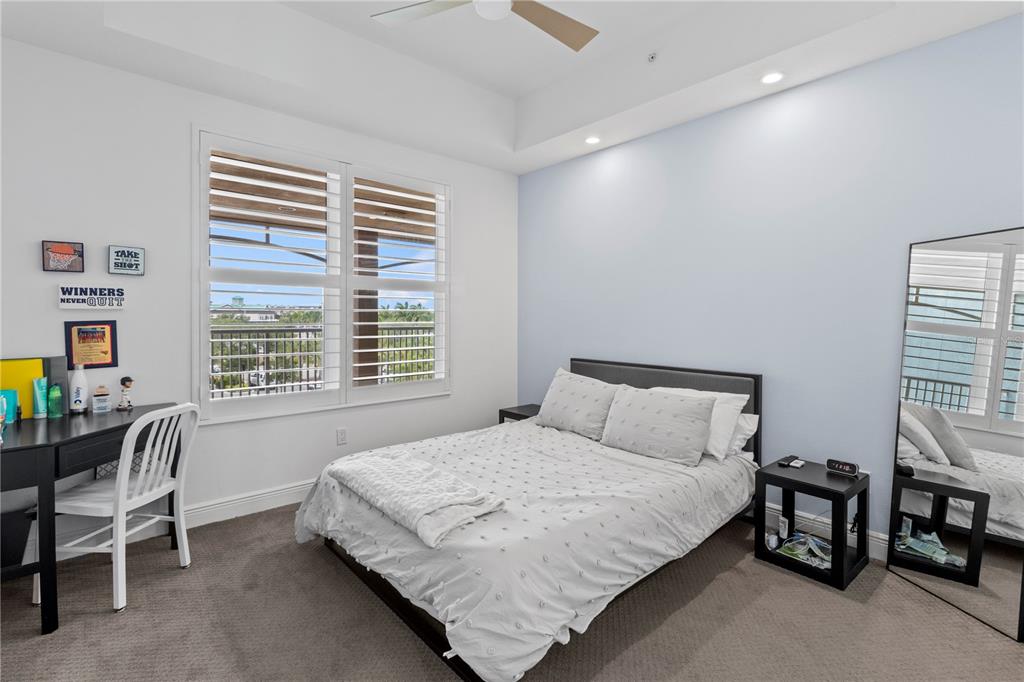 10520 Boardwalk Loop, Unit 302 Bradenton, FL 34202 - Photo 27 of 45 a bedroom with a bed chair and a window