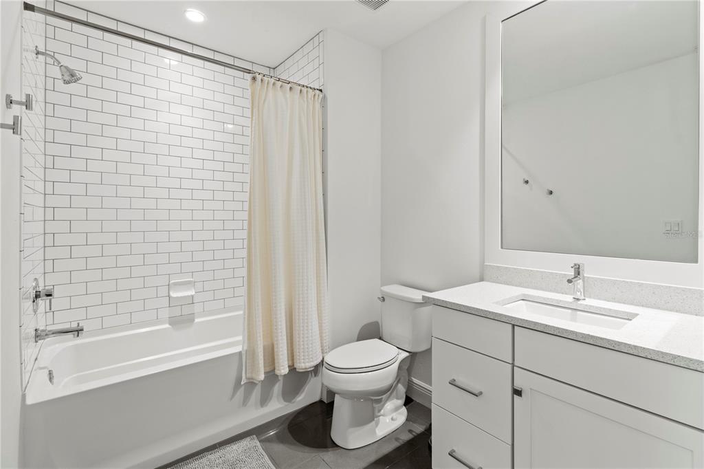 10520 Boardwalk Loop, Unit 302 Bradenton, FL 34202 - Photo 29 of 45 a bathroom with a sink toilet and shower