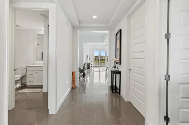 a view of a hallway with living room and dining room