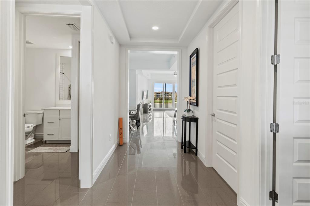 10520 Boardwalk Loop, Unit 302 Bradenton, FL 34202 - Photo 5 of 45 a view of a hallway with living room and dining room