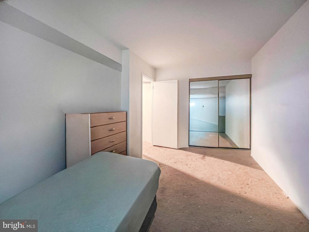 10843 Academy Road Philadelphia, PA 19154 - Photo 11 of 44 a bedroom with a bed and a mirror