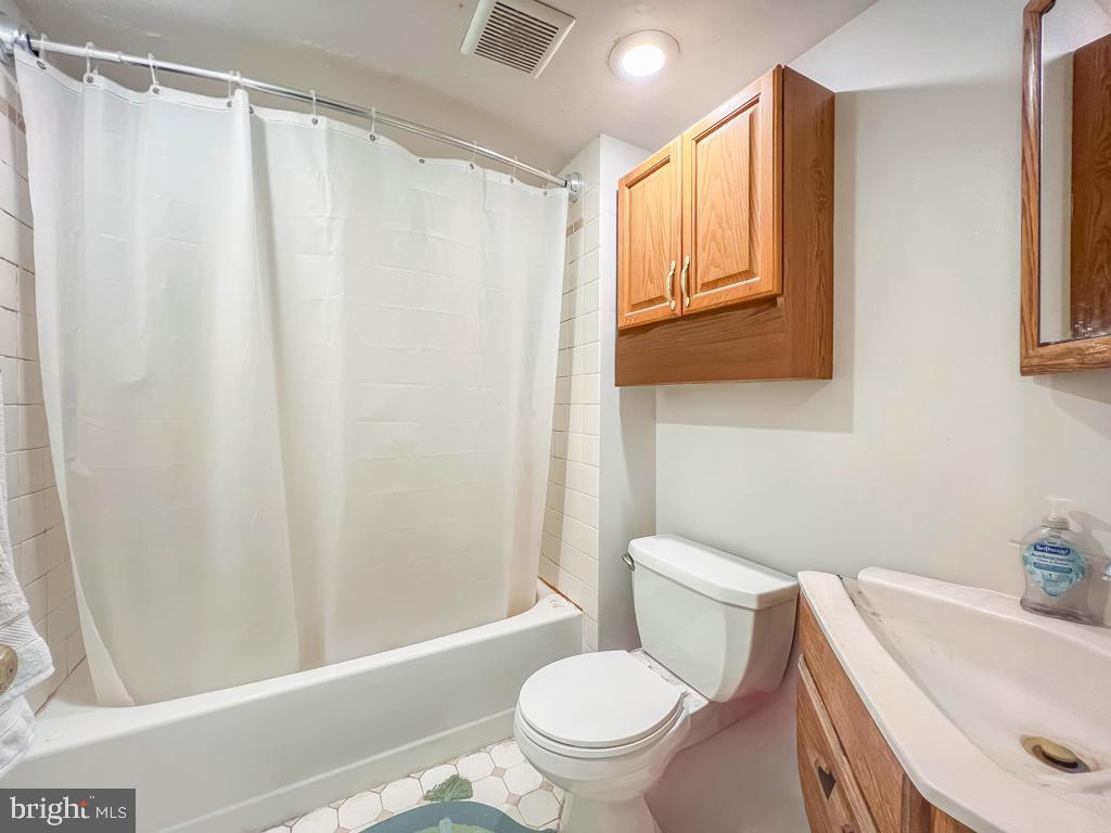 10843 Academy Road Philadelphia, PA 19154 - Photo 14 of 44 a white toilet sitting next to a bath tub
