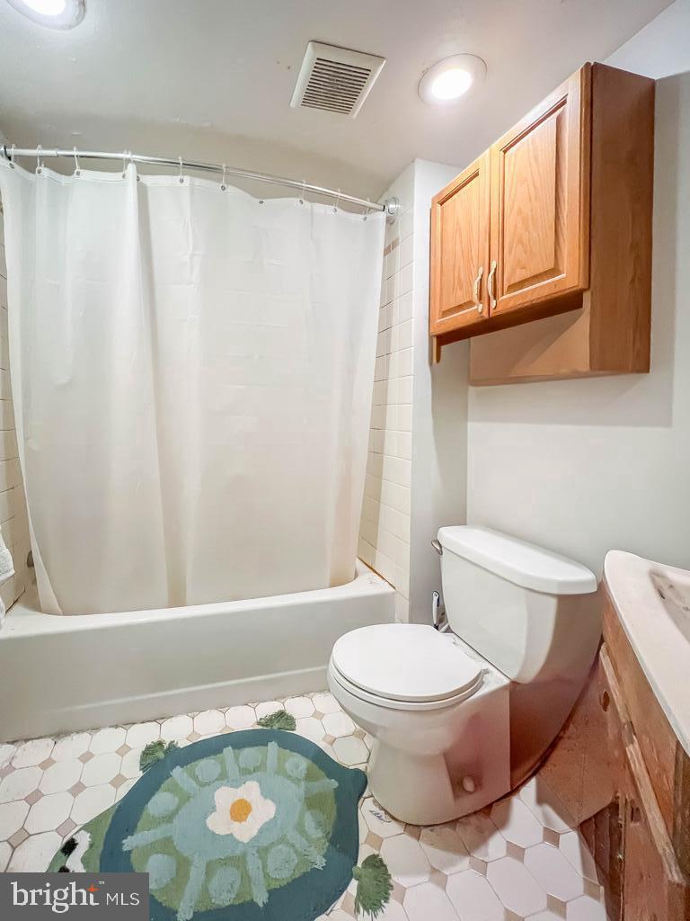 10843 Academy Road Philadelphia, PA 19154 - Photo 15 of 44 a white toilet sitting next to a bath tub