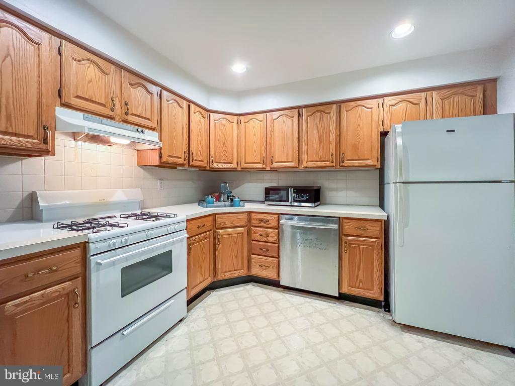 10843 Academy Road Philadelphia, PA 19154 - Photo 16 of 44 a kitchen with granite countertop a sink stainless steel appliances and cabinets