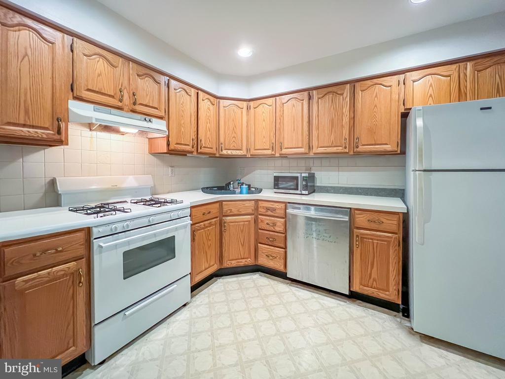 10843 Academy Road Philadelphia, PA 19154 - Photo 18 of 44 a kitchen with a stove sink and cabinets