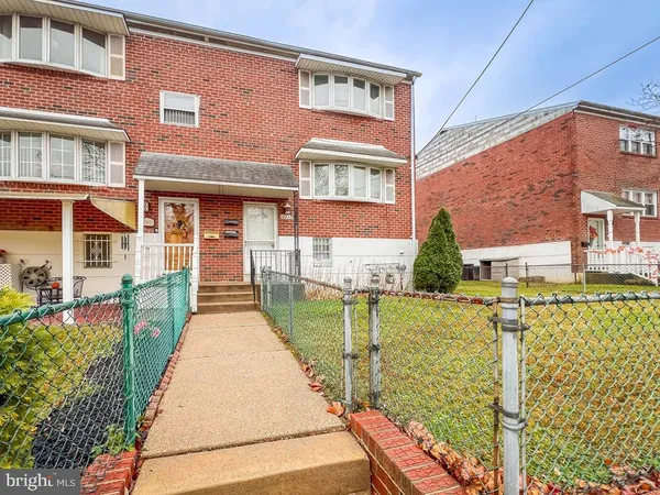 a view of a brick building next to a yard
