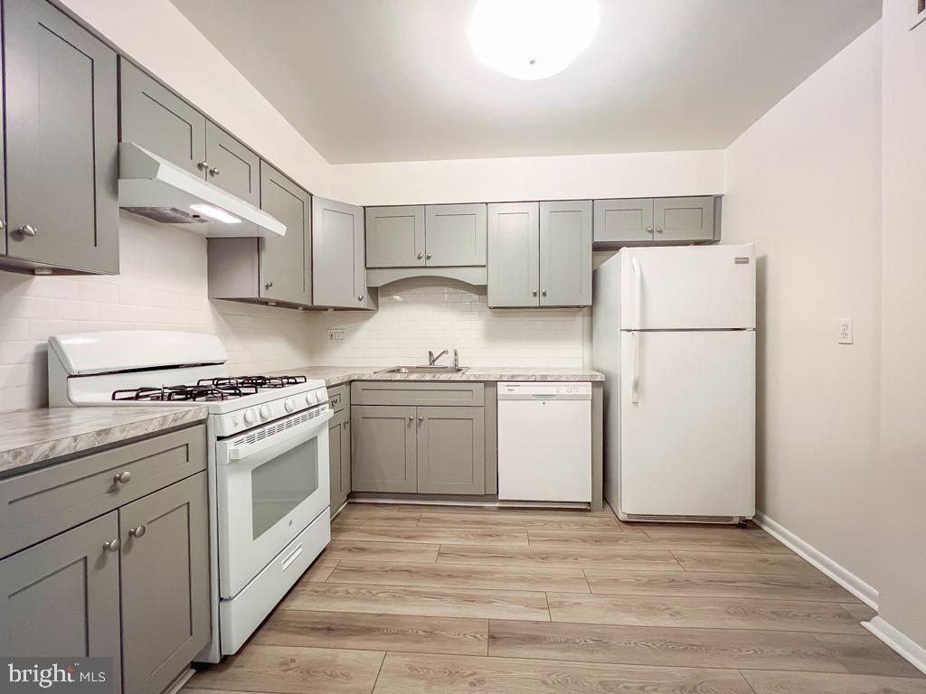 10843 Academy Road Philadelphia, PA 19154 - Photo 31 of 44 a kitchen with a white cabinets and white appliances