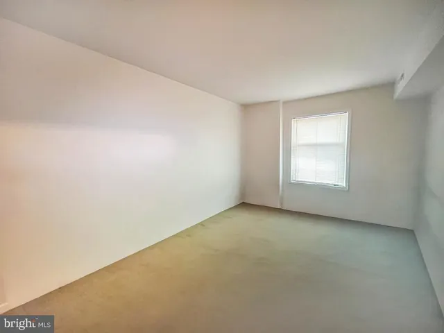 a bedroom with a bed and a mirror