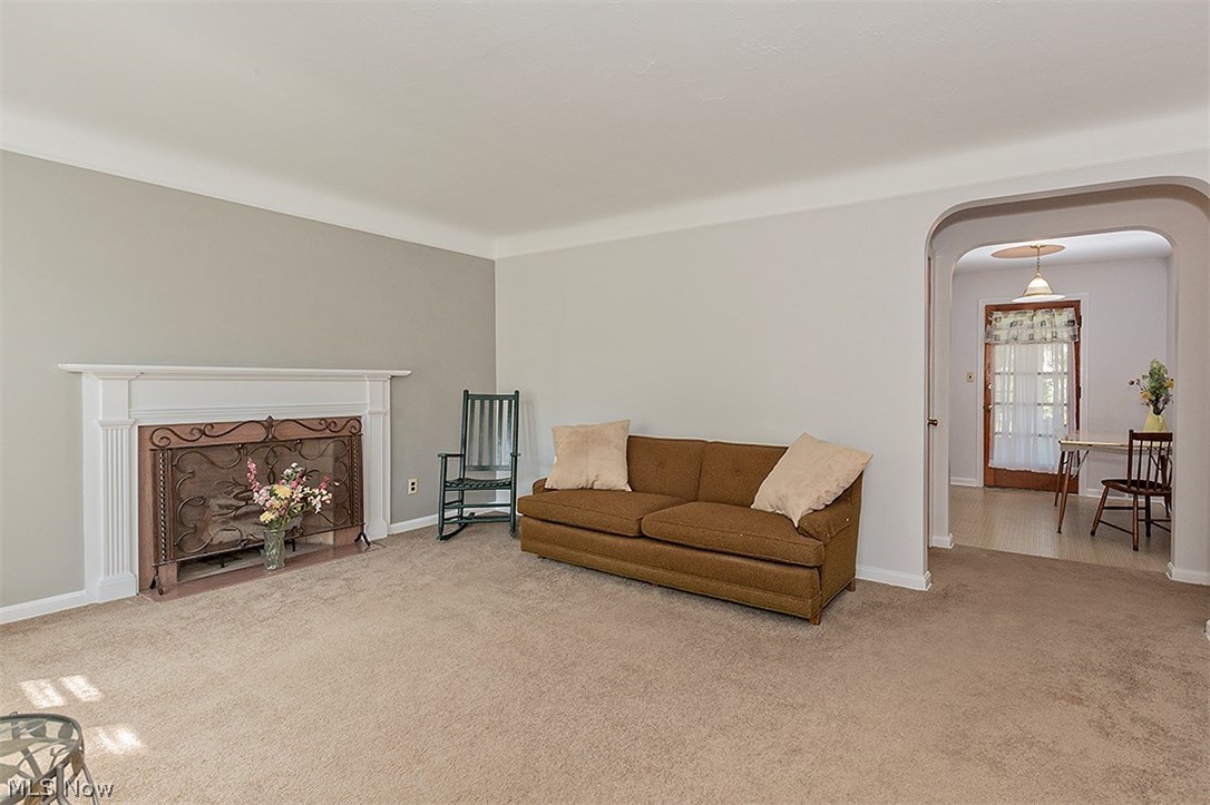 1672 Oakmount Road South Euclid, OH 44121 - Photo 3 of 30 The lovely Living Room was just painted... you'll love the stunning Fireplace, archways and coved ceilings. The carpeting is newer; however, there is Hardwood flooring underneath...