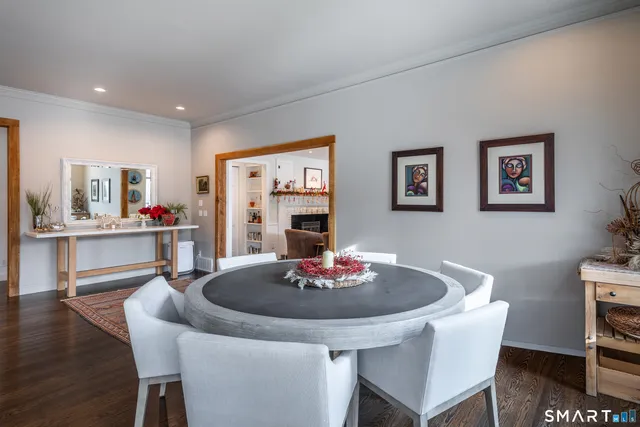 a dining room with furniture and wooden floor