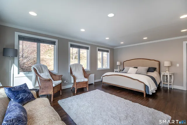 a spacious bedroom with bed and windows