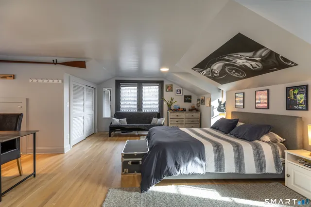 a bedroom with a large bed and a tv