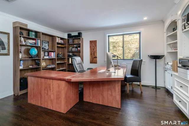 a dining room with stainless steel appliances granite countertop a table chairs and a window