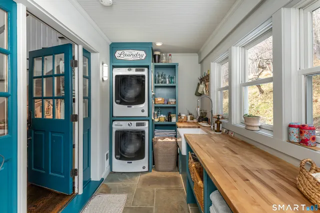 a view of a kitchen with a sink washer and dryer