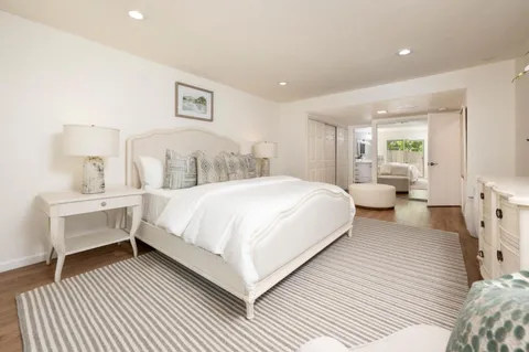 a spacious bedroom with a bed and a large window