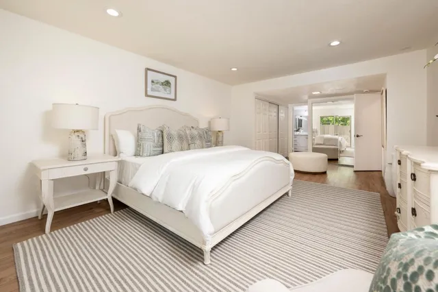 a spacious bedroom with a bed and a large window