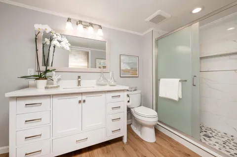 a spacious bedroom with a bed and a large window