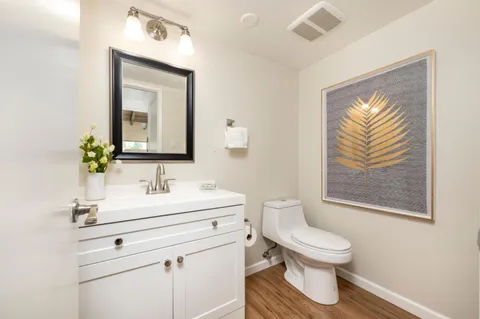 a view of a patio with couches table and chairs and potted plants