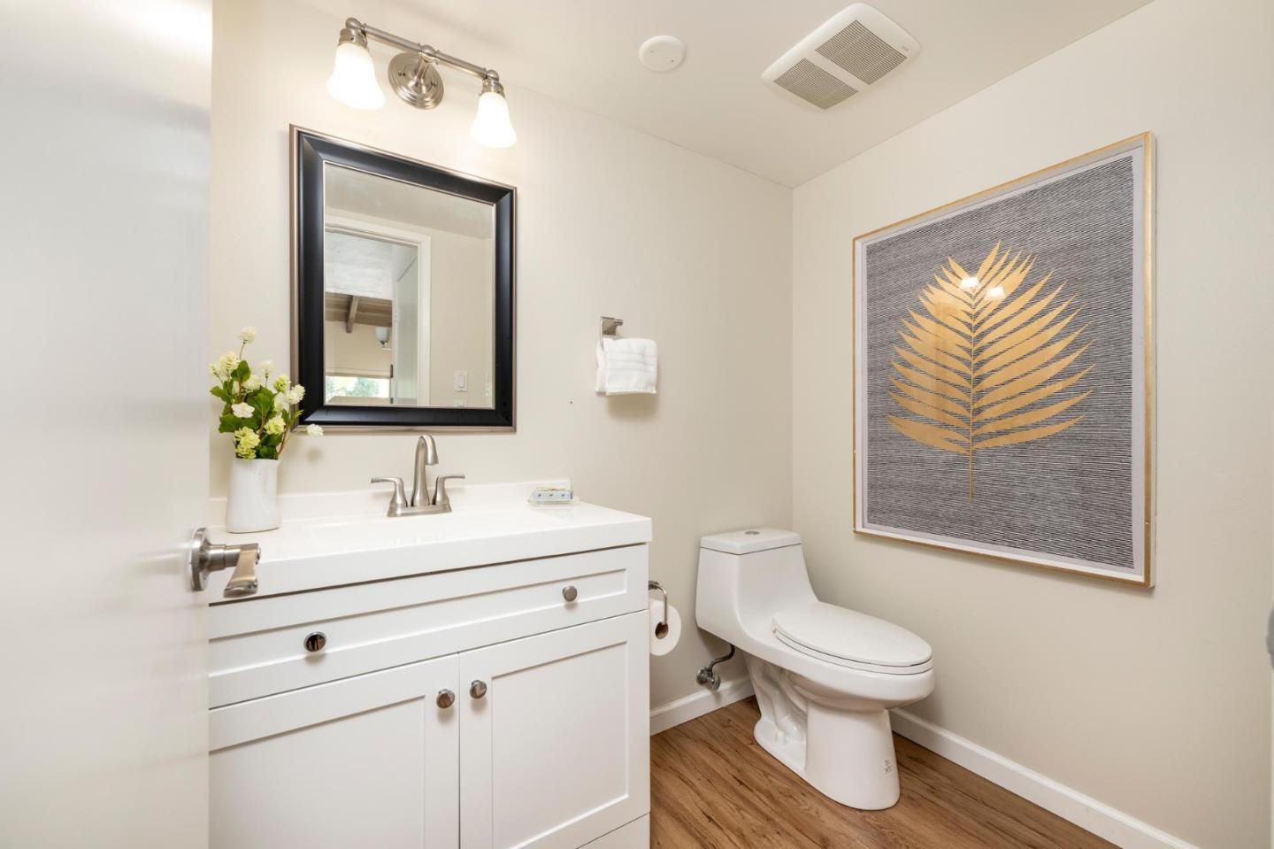 38 Weepingridge Court San Mateo, CA 94402 - Photo 16 of 25 a bathroom with a toilet sink and mirror