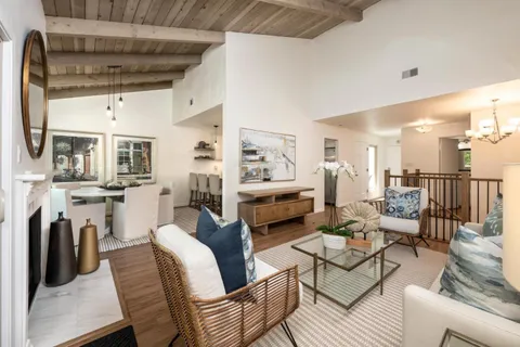 a living room with fireplace furniture and a table