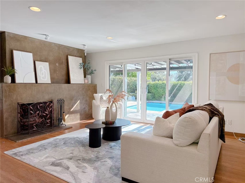 a living room with furniture floor to ceiling window and potted plant