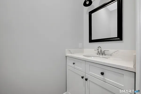 a bedroom with a bed lamp closet and window