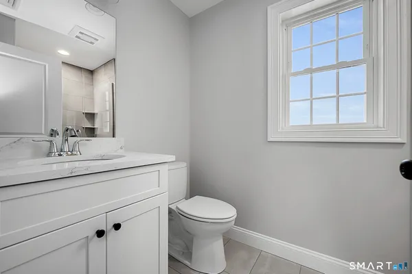 a view of empty room with cabinet and window