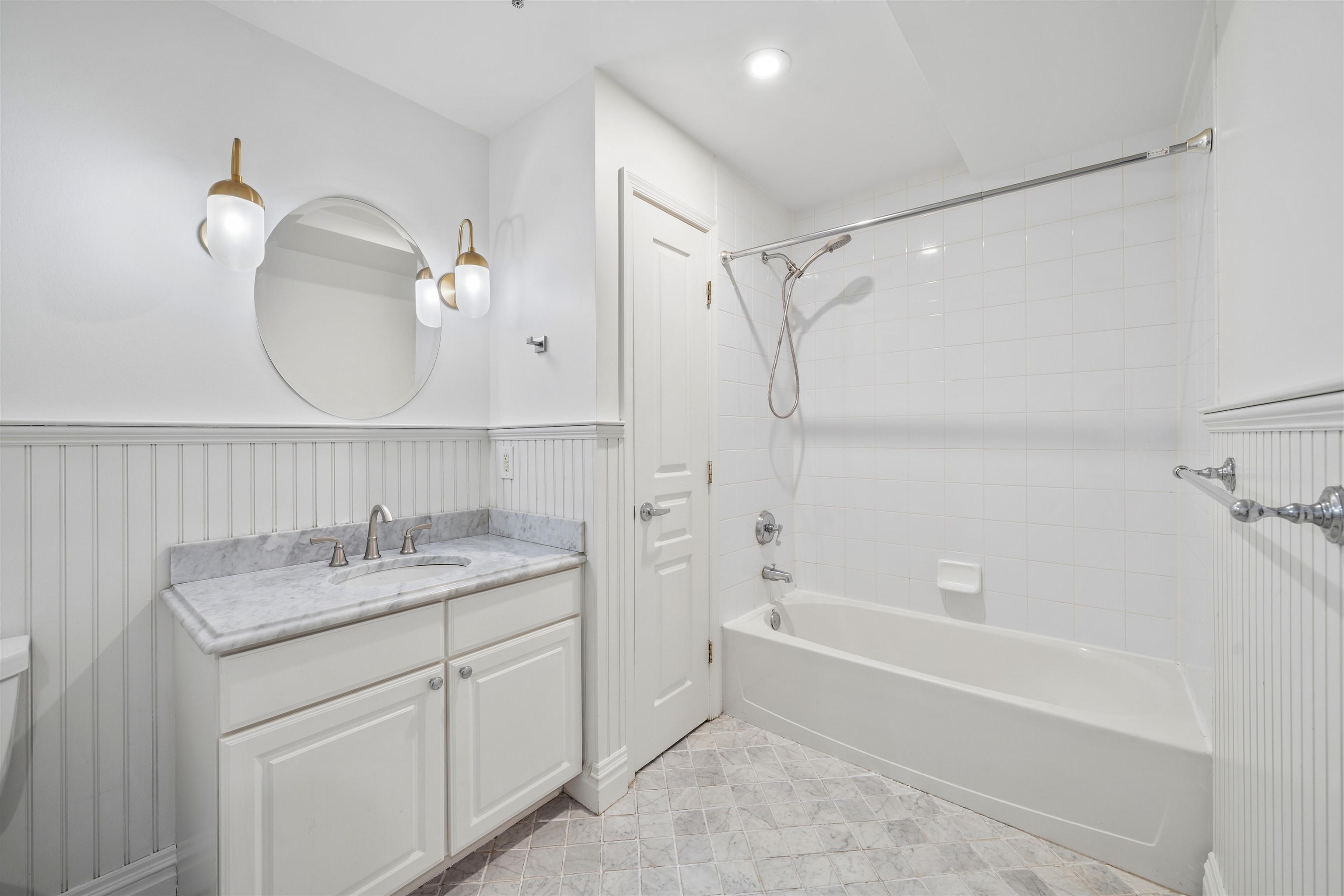 70 Adams Street, Unit 2F Hoboken, NJ 07030 - Photo 7 of 20 a bathroom with a granite countertop sink a mirror a vanity and a bathtub