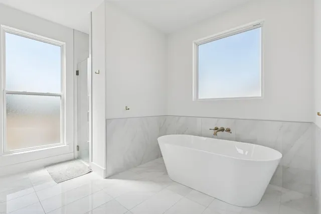 a white bath tub sitting in a bathroom