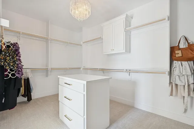 a kitchen with a refrigerator and white cabinets