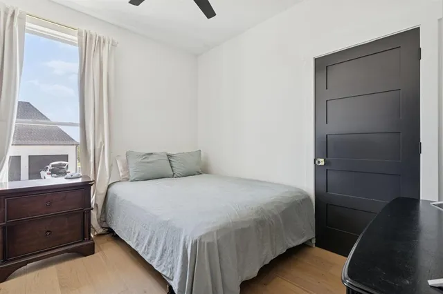 an empty room with a window and a fan