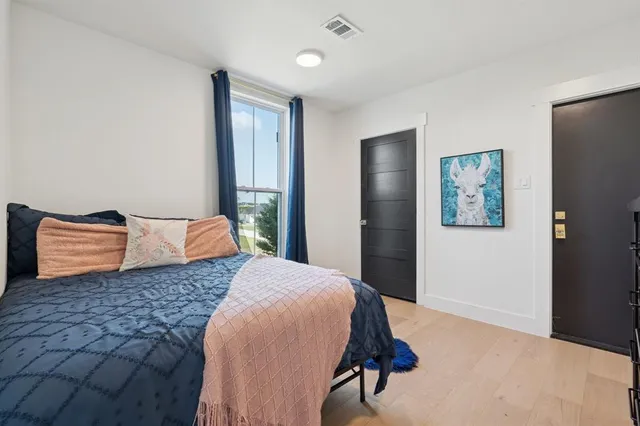 a bedroom with a bed and wall painting