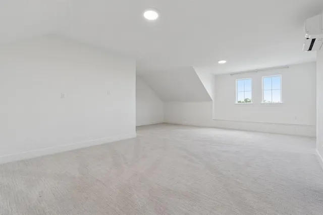 an empty room with a empty space and windows