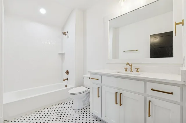 a bathroom with a sink a toilet and a bathtub