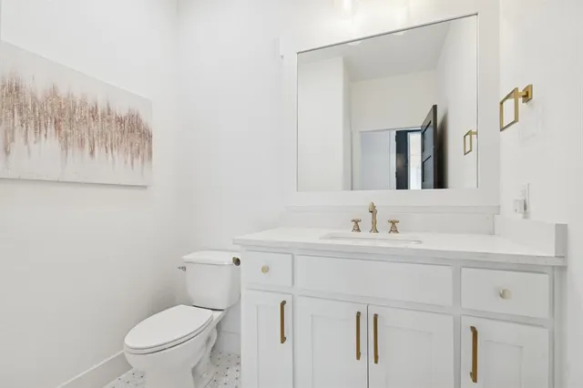 a bathroom with a toilet a sink and mirror