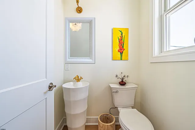 a bathroom with a toilet sink and mirror