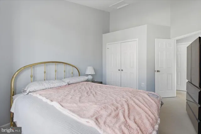 a large bed sitting in a bedroom and a mirror