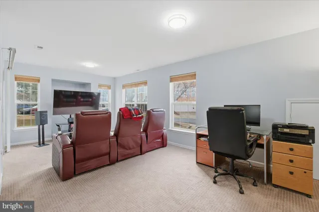 a living room with furniture window and a flat screen tv