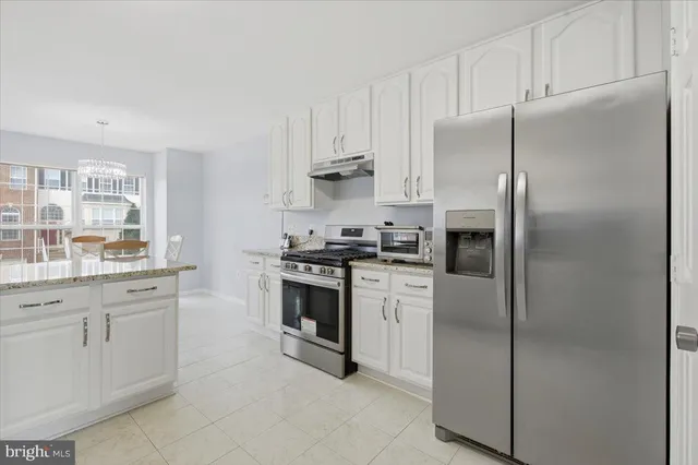 a kitchen with cabinets and stainless steel appliances