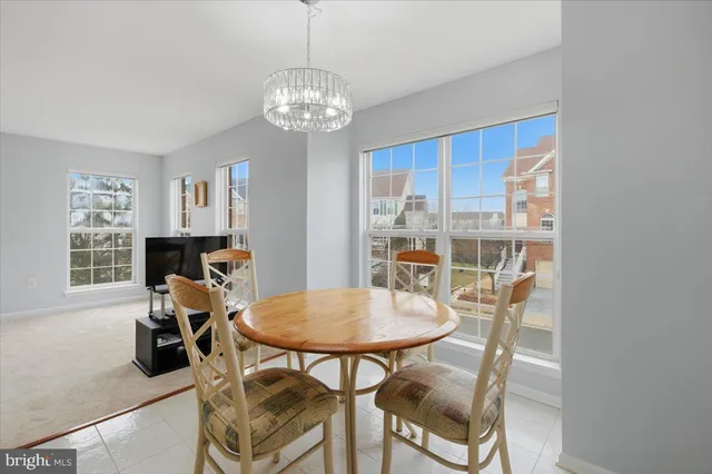 a view of a dining room with furniture and chandelier