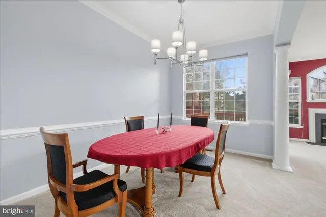 a view of a dining room with furniture and chandelier