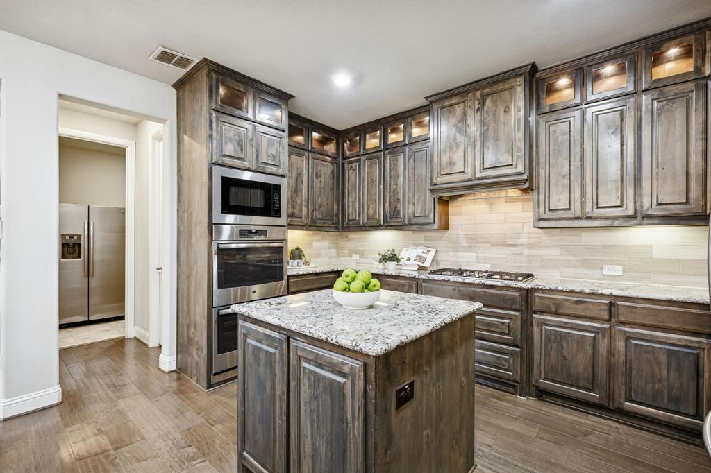 6333 Hall Road Frisco, TX 75034 - Photo 11 of 36 Laundry room and pantry off the kitchen. Laundry room comes with stainless steel fridge.