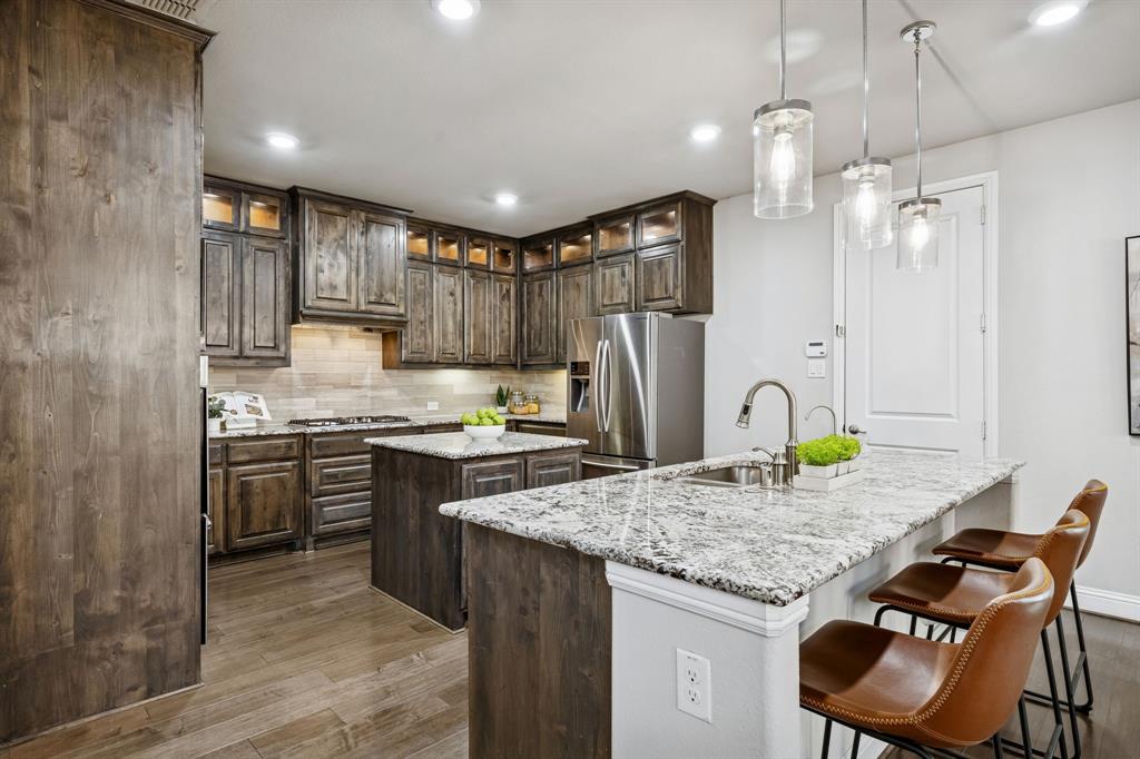6333 Hall Road Frisco, TX 75034 - Photo 9 of 36 Beautiful warm kitchen with plenty of cabinets and prep space.