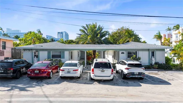 a front view of a house with parking space and a table