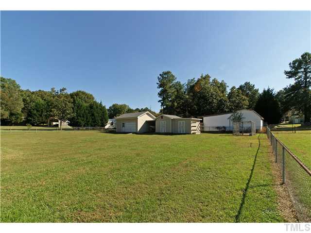 4120 Iverson Street Raleigh, NC 27604 - Photo 16 of 16 View of the 3 storage out buildings. Partially Fence yard. Fence runs down through the center of property!