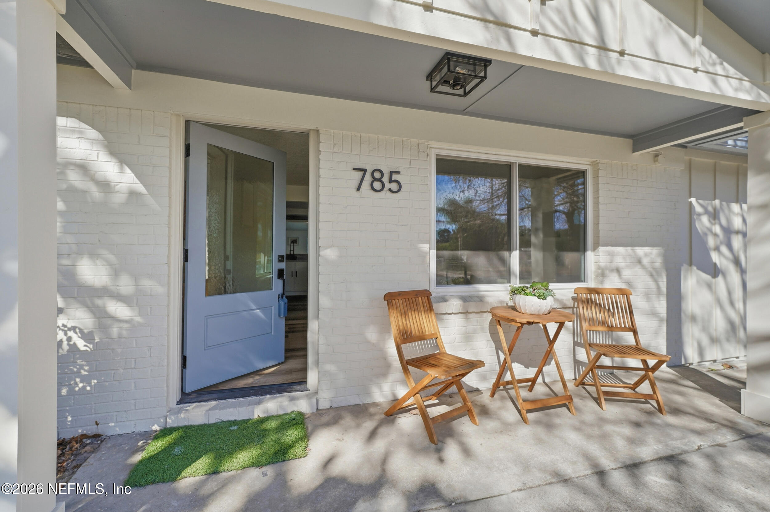 785 Triton Road Atlantic Beach, FL 32233 - Photo 2 of 54 a view of a patio with table and chairs next to a yard