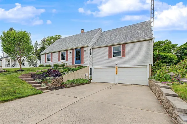 a front view of house with yard and green space