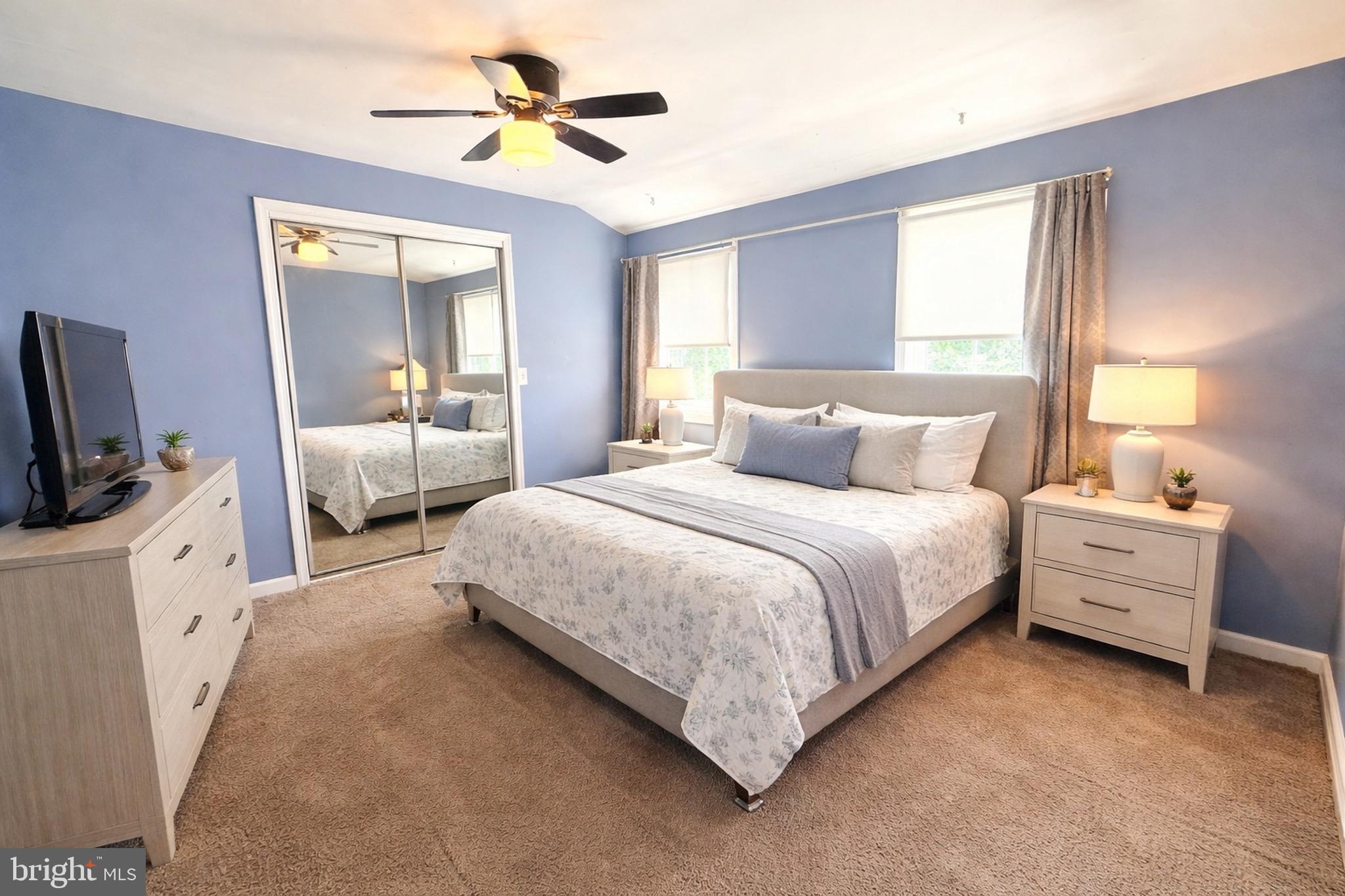 a bedroom with bed and a chandelier